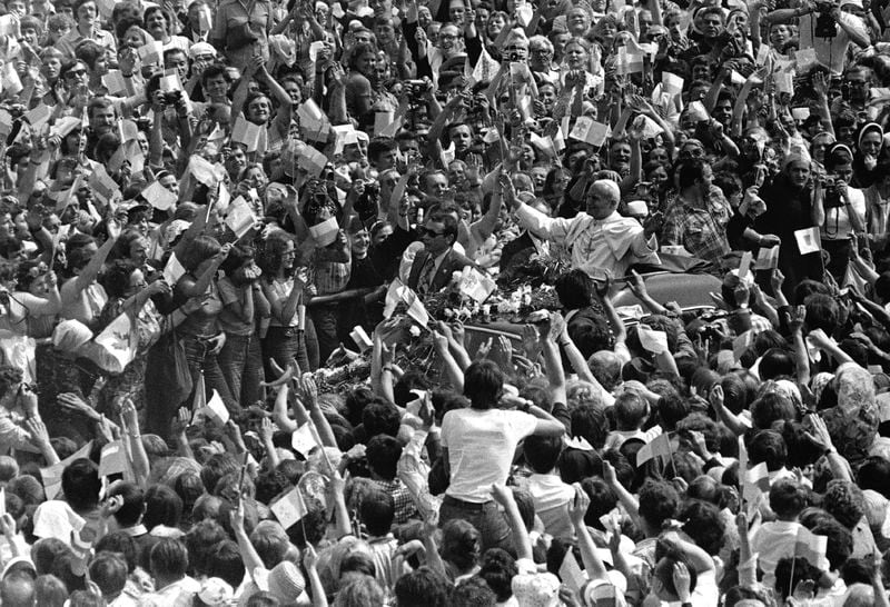 FILE - Pope John Paul II. stands in open car as he greets cheering crowd of believers, on the third day of the Pontiff's historical nine-day-visit to his homeland Poland, June 4, 1979 at Czestochowa near the famous monastery Jasna Gora. (AP Photo, File)