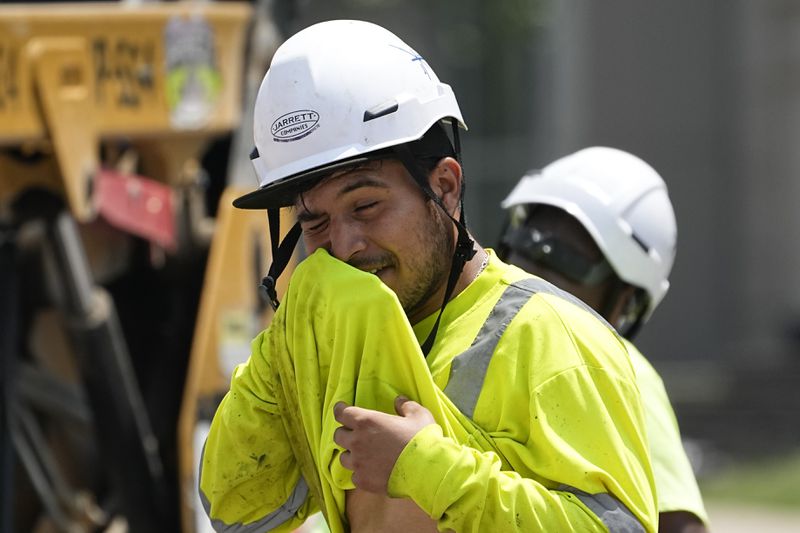 FILE - Construction worker Fernando Padilla wipes his face as he works in the heat on June 30, 2023 in Nashville, Tenn. (AP Photo/George Walker IV, File)