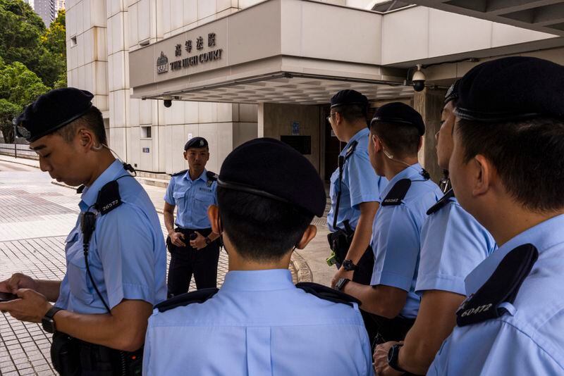 FILE - Police officers stand guard outside the High Court ahead of the hearing for an injunction to ban the 2019 protest song "Glory to Hong Kong" in Hong Kong, Friday, July 21, 2023. The distributor of a popular protest song in Hong Kong has decided to remove the music from all platforms because of a court ban in the city, the group that created the song said Friday, May 24, 2024, a week after YouTube blocked access to videos of it. (AP Photo/Louise Delmotte, File)