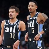 Atlanta Hawks guard Trae Young (11) and Atlanta Hawks guard Dejounte Murray (5) talk to one another during a break in their game against the Chicago Bulls at State Farm Arena, Monday, February 12, 2024, in Atlanta. (Jason Getz / jason.getz@ajc.com)