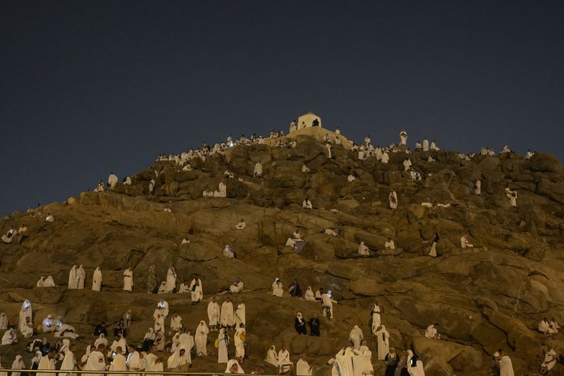 Muslim pilgrims gather at top of the rocky hill known as the Mountain of Mercy, on the Plain of Arafat, during the annual Hajj pilgrimage, near the holy city of Mecca, Saudi Arabia, Saturday, June 15, 2024. (AP Photo/Rafiq Maqbool)
