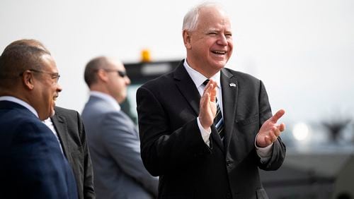 Minnesota Governor Tim Walz (center) awaits the arrival of US Vice President Kamala Harris at the Minneapolis-St. Paul International Airport in Saint Paul, Minnesota, on March 14, 2024. (Stephen Maturen/AFP via Getty Images/TNS)