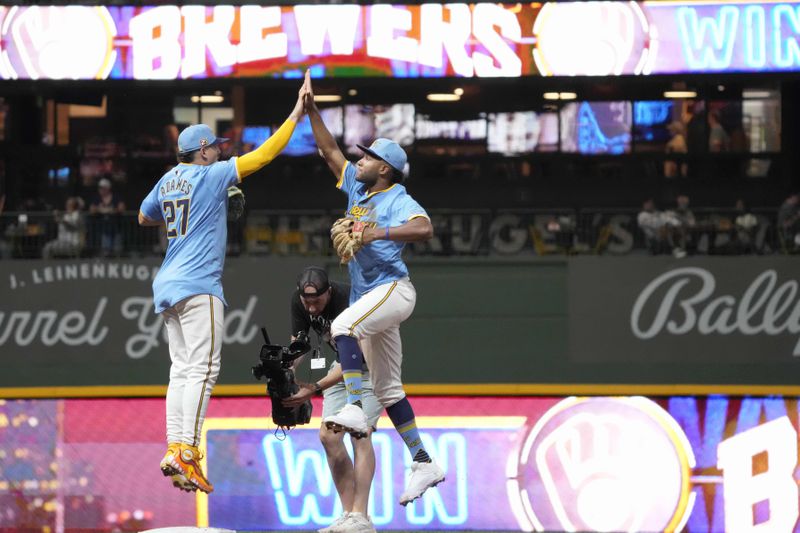 Milwaukee Brewers shortstop Willy Adames (27) and right fielder Jackson Chourio, right, celebrate after their win over the Cleveland Guardians, Friday, Aug. 16, 2024, in Milwaukee. (AP Photo/Kayla Wolf)