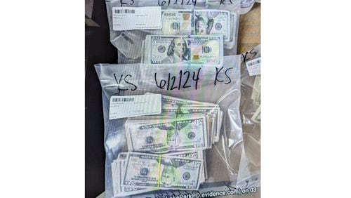 FILE - This image provided by the U.S. Attorney's Office for Minnesota, shows cash from a bag that was left at the home of a juror in a massive fraud case, June 2, 2024, outside Minneapolis, Minn. (U.S. Attorney's Office for Minnesota via AP, File)