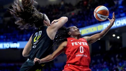 Indiana Fever guard Kelsey Mitchell (0) is blocked on a shot by Dallas Wings' Maddy Siegrist (20) in the first half of a WNBA basketball game Sunday, Sept. 1, 2024, in Arlington, Texas. (AP Photo/Tony Gutierrez)