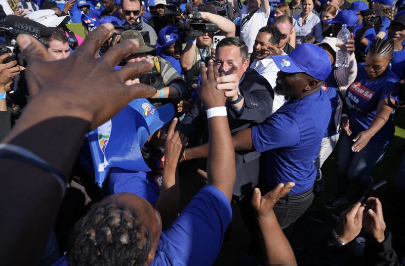 Main opposition Democratic Alliance (DA) party leader John Steenhuisen, center, greets supporters on arrival at a final election rally in Benoni, South Africa, Sunday, May 26, 2024. South Africa’s four main political parties have begun a final weekend of campaigning before a possibly pivotal election that could bring the country’s most important change in 30 years. (AP Photo/Themba Hadebe)