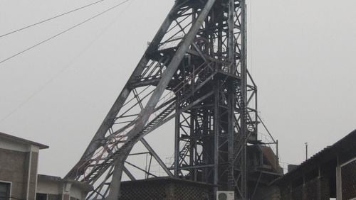 The Chinese flag is seen on a tower at a antimony mining company in Lengshuijiang in south China's Hunan province on Oct. 8, 2009. (Chinatopix via AP, File)