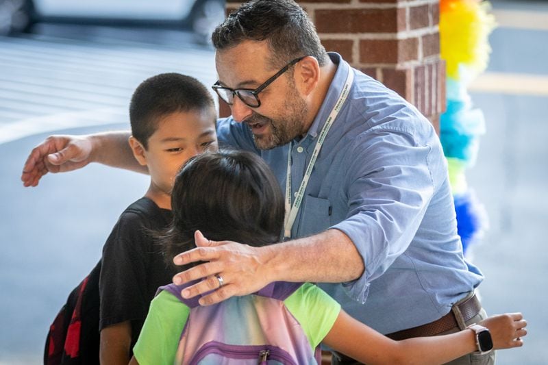 Virginia-Highland Elementary Principal Terry Harness greets students on the first day of school, Tuesday, Aug. 1, 2023. (Steve Schaefer/steve.schaefer@ajc.com)