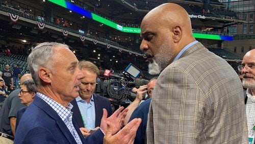 MLB Commissioner Rob Manfred and MLB Players Association executive director Tony Clark speak before Game 1 of the World Series on Oct. 26, 2021, in Houston. (AP Photo/Ron Blum)
