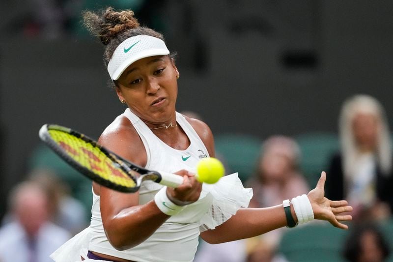 Naomi Osaka of Japan plays a forehand return to Emma Navarro of the United States during their match on day three at the Wimbledon tennis championships in London, Wednesday, July 3, 2024. (AP Photo/Alberto Pezzali)
