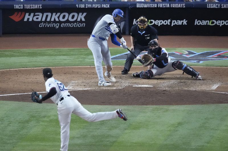 Los Angeles Dodgers' Shohei Ohtani hits a home run scoring Andy Pages off of Miami Marlins pitcher George Soriano (62) during the sixth inning of a baseball game, Thursday, Sept. 19, 2024, in Miami. (AP Photo/Wilfredo Lee)