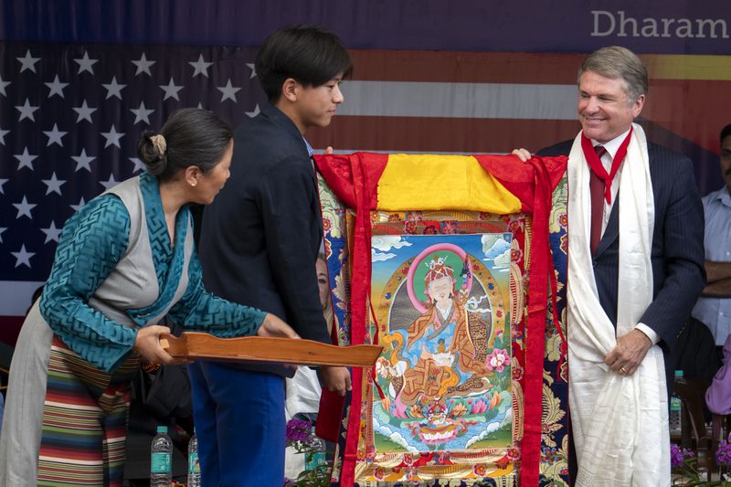 Republican Rep. Michael McCaul, right, is presented with a traditional Tibetan Buddhist painting called Thangka at a public event during which a US delegation led by Rep. McCaul was felicitated by the President of the Central Tibetan Administration and other officials at the Tsuglakhang temple in Dharamshala, India, Wednesday, June 19, 2024. (AP Photo/Ashwini Bhatia)