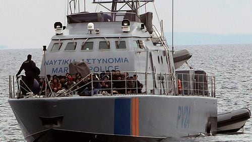 FILE - Migrants aboard a Cyprus marine police patrol boat as they're brought to a harbor after being rescued from their own vessel off the Mediterranean island nation's southeastern coast of Protaras, Cyprus, on Jan. 14, 2020. (AP Photo/Petros Karadjias, File)