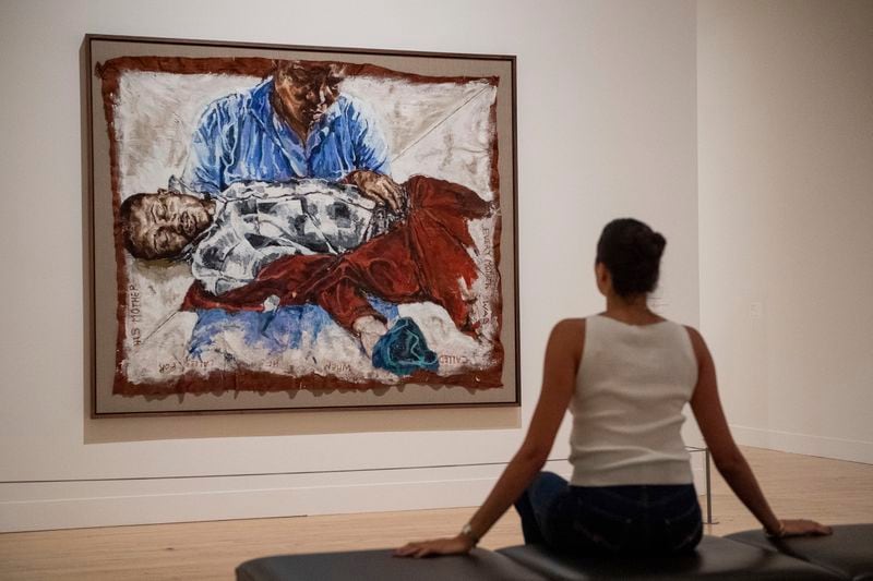 A woman looks at an artwork by Claudette Johnson during the Turner Prize 2024 press preview at Tate Britain in London, part of the 40th anniversary exhibition featuring four shortlisted artists, Tuesday, Sept. 24, 2024. (AP Photo/Thomas Krych)