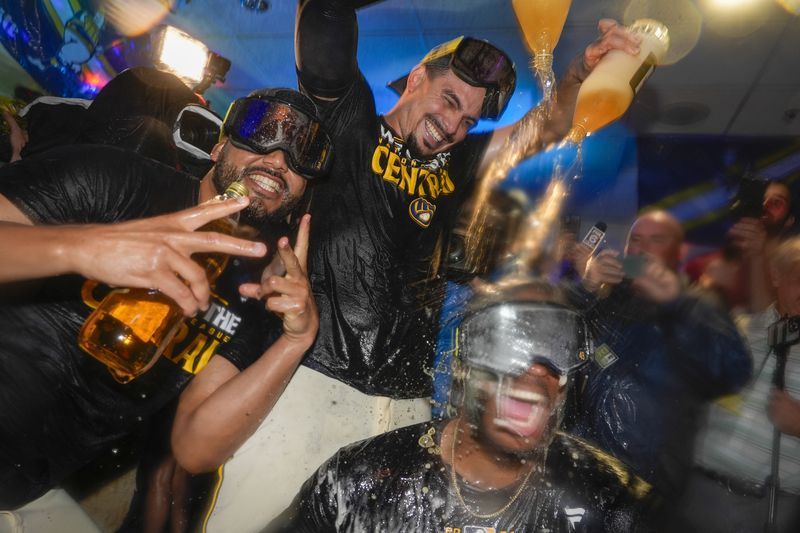 Milwaukee Brewers' Willy Adames douces Enoli Paredes after a baseball game against the Philadelphia Phillies Wednesday, Sept. 18, 2024, in Milwaukee. The Brewers won 2-1 and clinched the National League Central division. (AP Photo/Morry Gash)