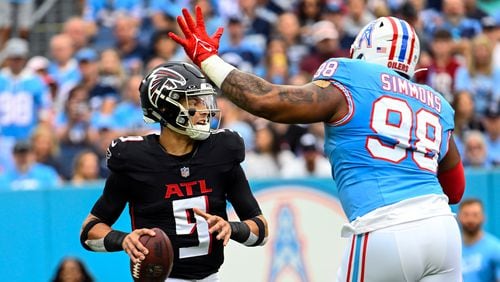 Atlanta Falcons quarterback Desmond Ridder (9) looks for an open receiver as Tennessee Titans defensive tackle Jeffery Simmons (98) rushes during the first half of an NFL football game, Sunday, Oct. 29, 2023, in Nashville, Tenn. (AP Photo/John Amis)