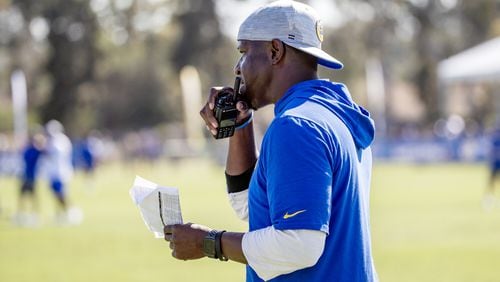 Rams defensive coordinator Raheem Morris speaks into a communication device. ((Gina Ferazzi/Los Angeles Times/TNS)