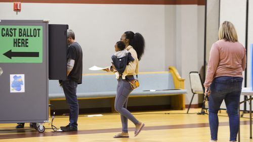 Tamia Gabriel (middle) waits to cast her ballot on Tuesday, November 8, 2022, at Elizabeth Baptist Church in Marietta, Georgia. Voters cast their ballots for the midterm elections. CHRISTINA MATACOTTA FOR THE ATLANTA JOURNAL-CONSTITUTION.
