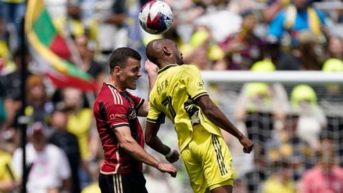 Nashville SC midfielder Fafà Picault (7) heads the ball past Atlanta United defender Brooks Lennon (11) during the first half of an MLS soccer match on Saturday, April 29, 2023, in Nashville, Tenn. (AP Photo/George Walker IV)