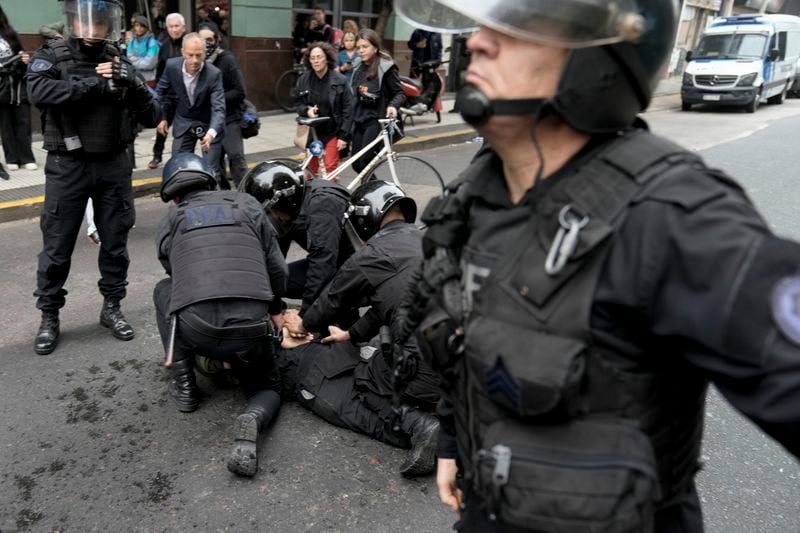 Police detain an anti-government protester outside Congress where lawmakers debate a reform bill promoted by Argentine Javier Milei in Buenos Aires, Argentina, Wednesday, June 12, 2024. (AP Photo/Rodrigo Abd)