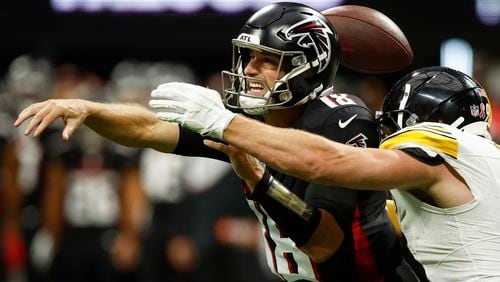 Atlanta Falcons quarterback Kirk Cousins (18) loses the ball as he is hit by Pittsburgh Steelers linebacker T.J. Watt during the second half of an NFL football game Sunday, Sept. 8, 2024, in Atlanta. (AP Photo/Butch Dill)