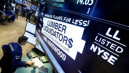 FILE - Specialist Anthony Rinaldi works on the floor of the New York Stock Exchange on Feb. 1, 2016, adjacent to the post that handles Lumber Liquidators. (AP Photo/Richard Drew, File)