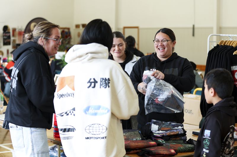 Cousins Summer Quinn and Danielle Quinn, second right, talk to customers at their stall during Matariki Whanau Day at the Wainuiomata Community Hub, Wellington, New Zealand on June 22, 2024. Now in its third year as a nationwide public holiday in New Zealand, Matariki marks the lunar new year by the rise of the star cluster known in the Northern Hemisphere as the Pleiades. (AP Photo/Hagen Hopkins)