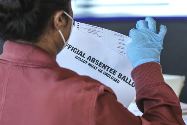 A Fulton County election worker scans absentee ballots in 2020. For the 2024 election, voters can track their ballots through the state's My Voter Page. (John Spink/AJC 2020)