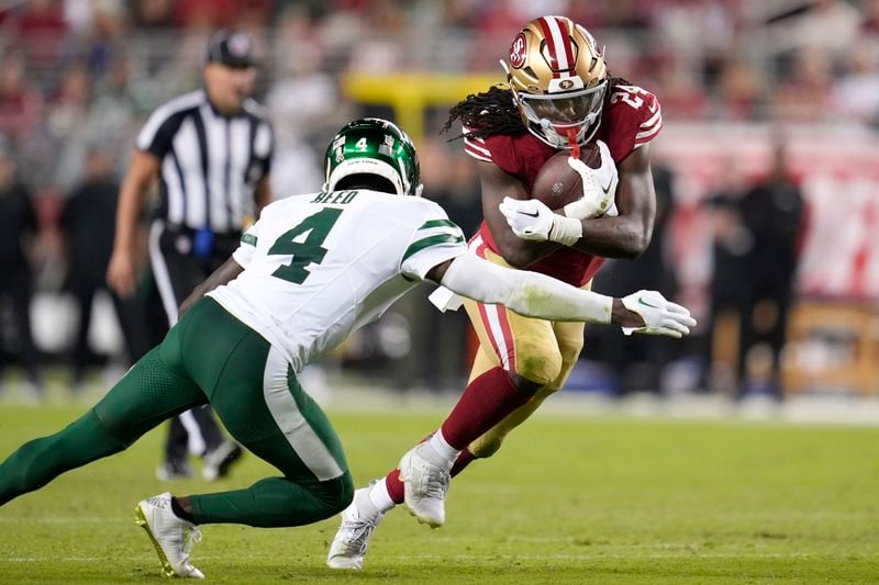 San Francisco 49ers running back Jordan Mason, right, runs against New York Jets cornerback D.J. Reed (4) during the second half of an NFL football game in Santa Clara, Calif., Monday, Sept. 9, 2024. (AP Photo/Godofredo A. Vásquez)