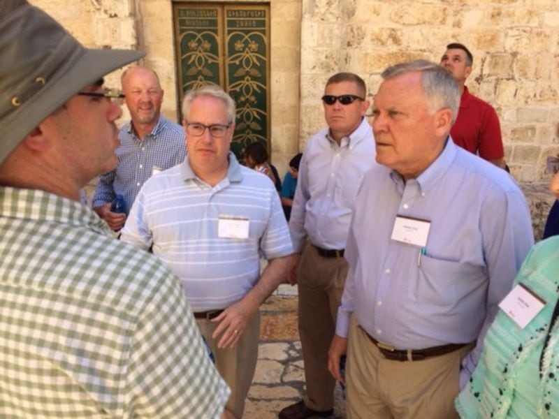 Gov. Nathan Deal and Georgia Attorney General Sam Olens listen to a tour guide outside the Church of the Holy Sepulchre, one of the holiest Christian sites in Jerusalem. While on his trade mission to Israel, the governor has prayed outside Christian holy sites and also visited the Western Wall, the most sacred place in Judaism. GREG BLUESTEIN / GBLUESTEIN@AJC.COM