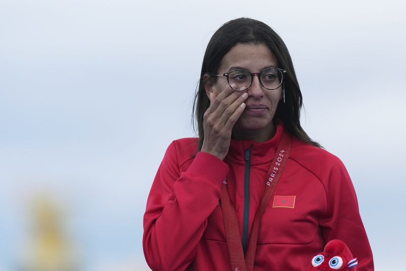 Morocco's Fatima Ezzahra El Idrissi reacts on the podium with her gold medal after winning the women's marathon T12 at the 2024 Paralympic Games in Paris, France, Sunday, September 8, 2024. (AP Photo/Thibault Camus)