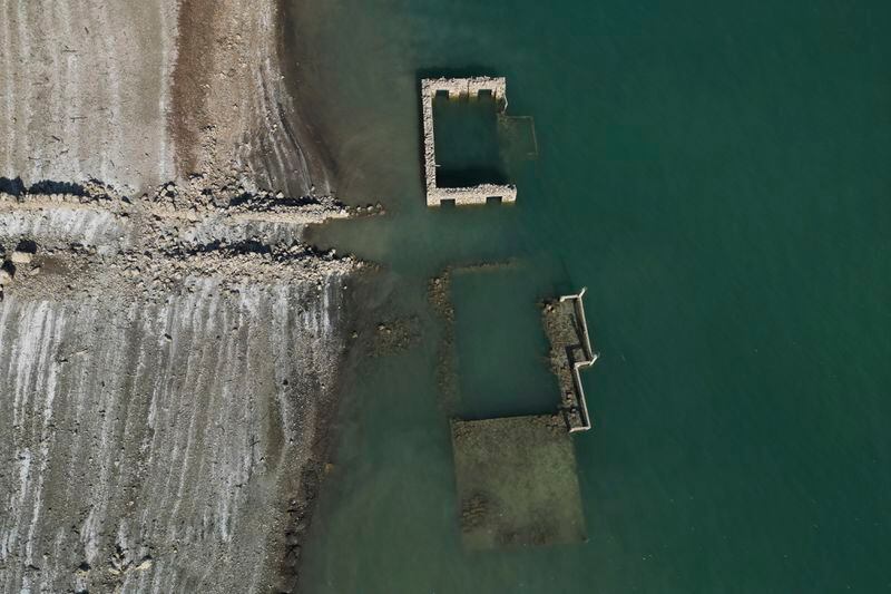 The ruins of sunken Kallio village are seen from above at the artificial Mornos Lake, some 200 kilometers (125 miles) northwest from Athens, central Greece, on Thursday, Sept. 5, 2024. (AP Photo/Thanassis Stavrakis)