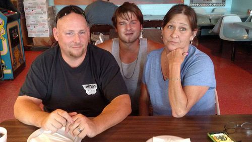 FILE - This August 2017 family photo shows Austin Hunter Turner with his mother, Karen Goodwin, and her husband, Brian, at a pizza restaurant in Bristol, Tenn., a week before Hunter's death. It is the last photo of them together. (Family photo via AP, File)