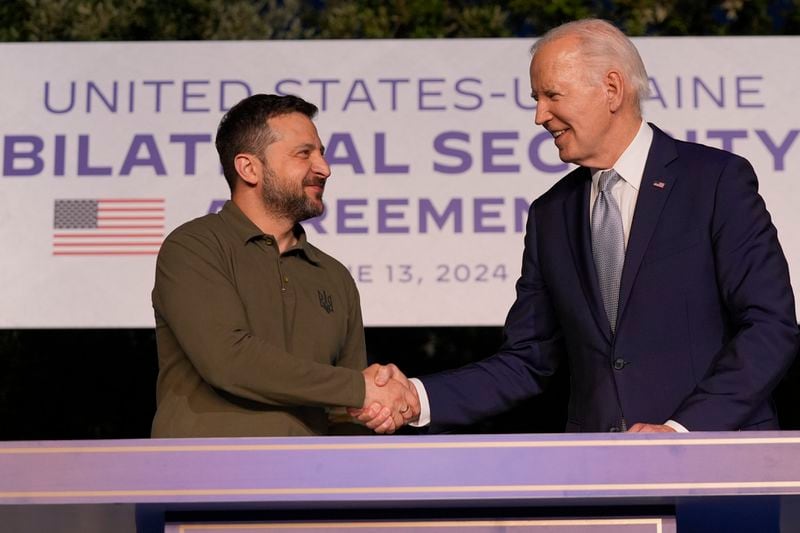 President Joe Biden (right) and Ukrainian President Volodymyr Zelenskyy (left) shake hands after signing a security agreement on the sidelines of the G7 on Thursday in Savelletri, Italy.