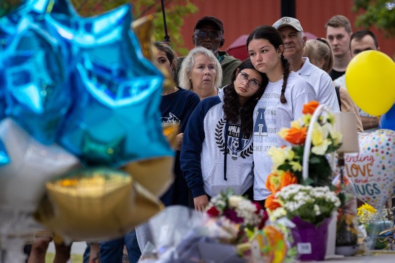 (L-R) Maya Soto and Lana Kriskovic comfort each other at a vigil at Jug Tavern Park in Winder on Friday, Sept. 6, 2024. A 14-year-old Apalachee High School student is accused of shooting and killing two fellow students and two teachers and injuring nine others at the Barrow County high school on Wednesday.