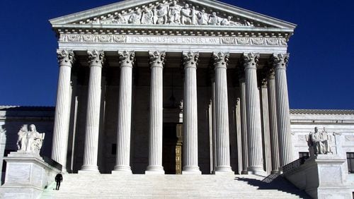 WASHINGTON -- A police officer walks up the steps of the U.S. Supreme Court building in 2001. Rick McKay/Cox News Service)