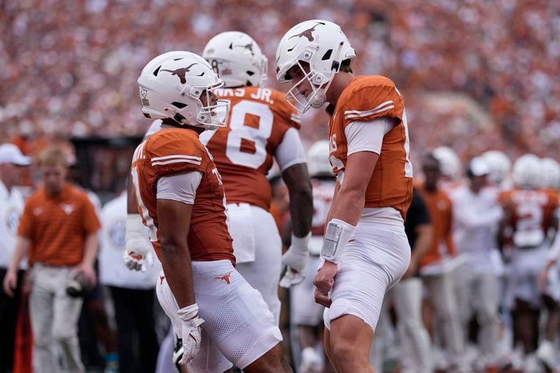 Texas wide receiver DeAndre Moore Jr., left, celebrates his touchdown with quarterback Arch Manning, right, during the first half of an NCAA college football game against UTSA in Austin, Texas, Saturday, Sept. 14, 2024. (AP Photo/Eric Gay)