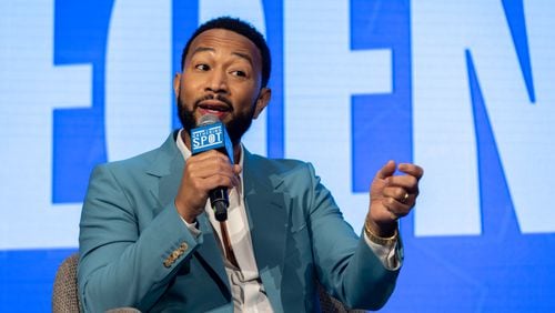 Singer John Legend speaks Monday at the Gathering Spot in Atlanta. Legend, who supports Vice President Kamala Harris, said this election is particularly important to him because he wants to make sure his daughters, Luna and Esti, grow up in a world with access to reproductive care, including abortion. (Arvin Temkar / AJC)