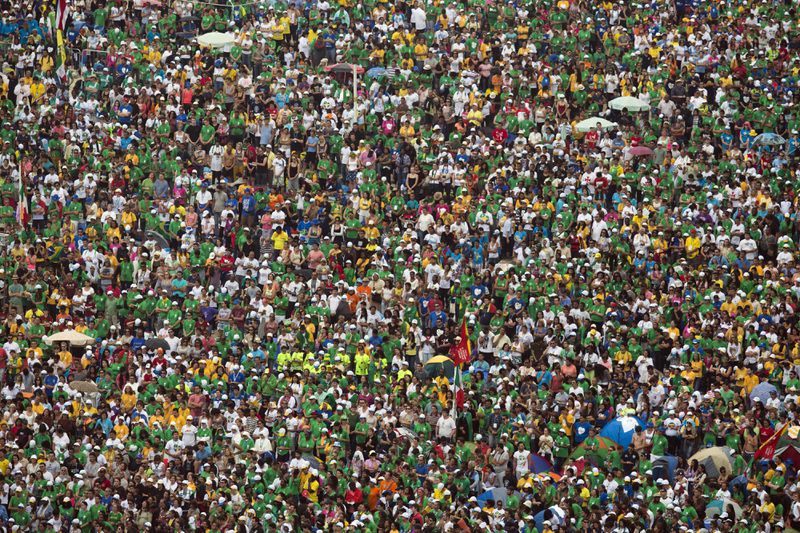 FILE - People attend the World Youth Day's closing Mass celebrated by Pope Francis on the Copacabana beachfront, in Rio de Janeiro, Brazil, on July 28, 2013. (AP Photo/Felipe Dana, File)