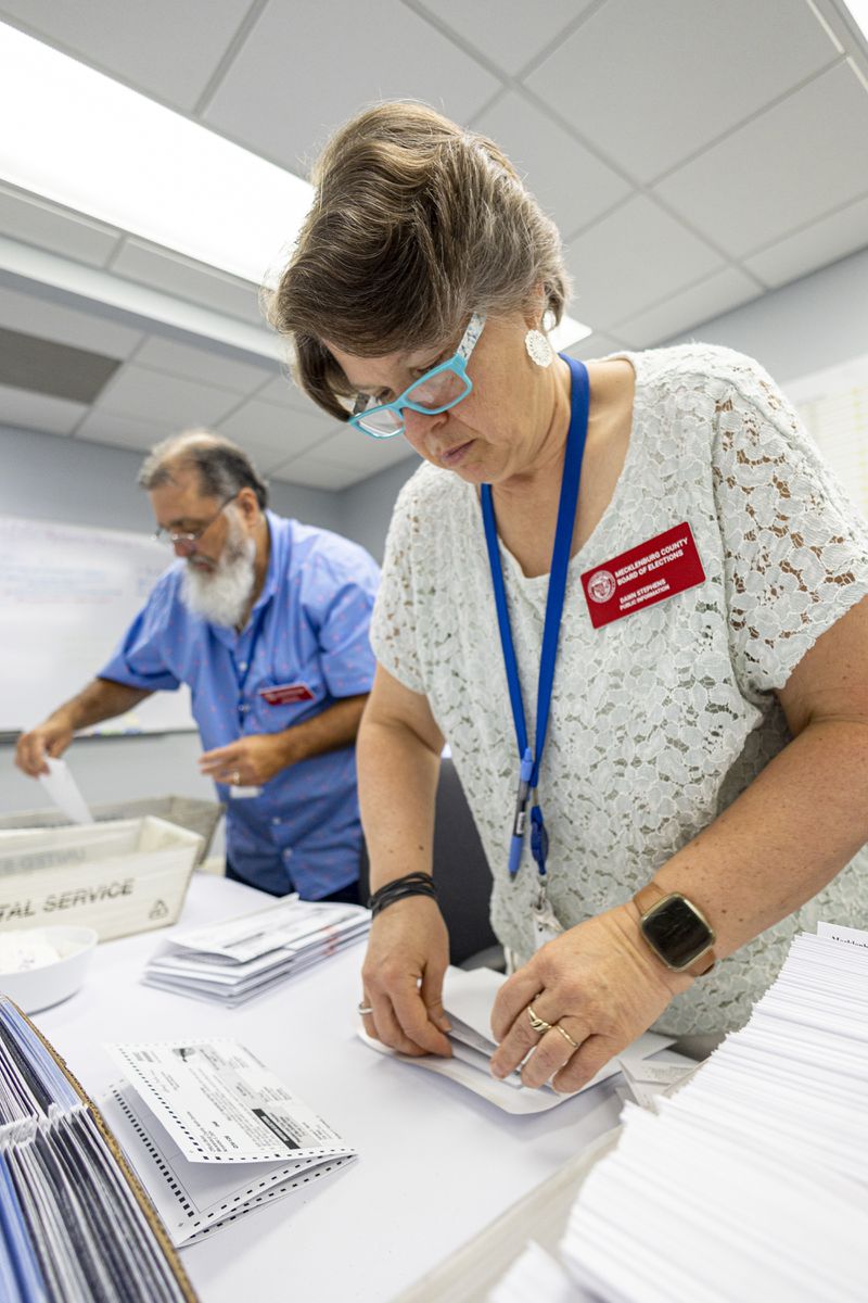 Dawn Stephens, right, and Duane Taylor prepare ballots to be mailed at the Mecklenburg County Board of Elections in Charlotte, N.C., Thursday, Sept. 5, 2024. (AP Photo/Nell Redmond)