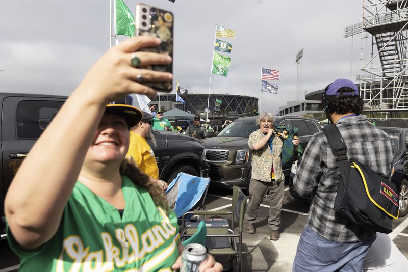 Andrew Johnstone plays the bagpipes outside the Oakland Coliseum before a baseball game between the Oakland Athletics and the Texas Rangers Thursday, Sept. 26, 2024, in Oakland, Calif. (AP Photo/Benjamin Fanjoy)