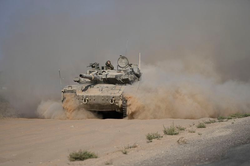 An Israeli tank maneuvers near the Israel-Gaza border in southern Israel, Friday, July 12, 2024. (AP Photo/Tsafrir Abayov)