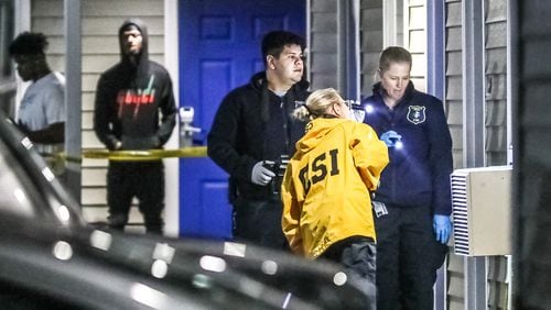 Investigators collected evidence and spoke with witnesses Feb. 22, 2022, at the Intown Suites on Stone Mountain Highway after a woman was found shot to death inside a room.