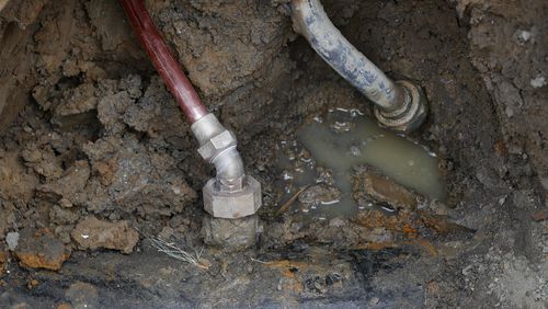 FILE - A copper water supply line, left, is shown connected to a water main after being installed for lead pipe, right, July 20, 2018, in Flint, Mich. (AP Photo/Paul Sancya, File)