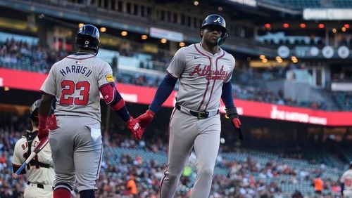 Atlanta Braves' Jorge Soler, right, celebrates with Michael Harris II (23) after scoring against the San Francisco Giants during the first inning of a baseball game Wednesday, Aug. 14, 2024, in San Francisco. (AP Photo/Godofredo A. Vásquez)