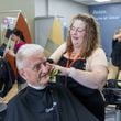 Salon Manager Susan Perdue (right), at Great Clips in Cumming, talks with Richard Herrmann as she cuts his hair. Perdue, who was born deaf, communicates with her clients by reading their lips in the mirror as she stands behind them styling their hair. PHIL SKINNER FOR THE ATLANTA JOURNAL-CONSTITUTION