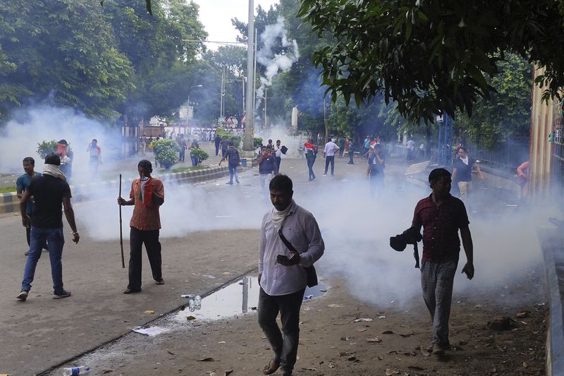 Police fire tear gas shells to disperse people protesting against the rape and murder of a resident doctor at a government hospital earlier this month, in Kolkata, India, Tuesday, Aug. 27, 2024. (AP Photo/Bikas Das)