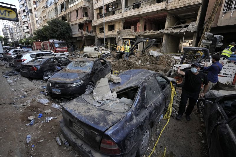 Damaged cars at the site of Friday's Israeli strike in Beirut's southern suburbs, Saturday, Sept. 21, 2024. (AP Photo/Bilal Hussein)