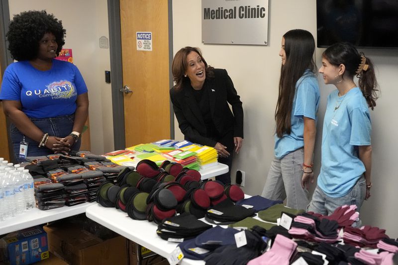 Democratic presidential nominee Vice President Kamala Harris, second left, greets workers at a food drop-off and distribution center after receiving a briefing on the damage from Hurricane Helene, Saturday, October 5, 2024, in Charlotte, N.C. (AP Photo/Chris Carlson)