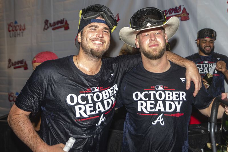 The Atlanta Braves celebrate in the locker room after clinching a wild-card playoff berth after the second baseball game of a doubleheader against the New York Mets, Monday, Sept. 30, 2024, in Atlanta. (AP Photo/Jason Allen)